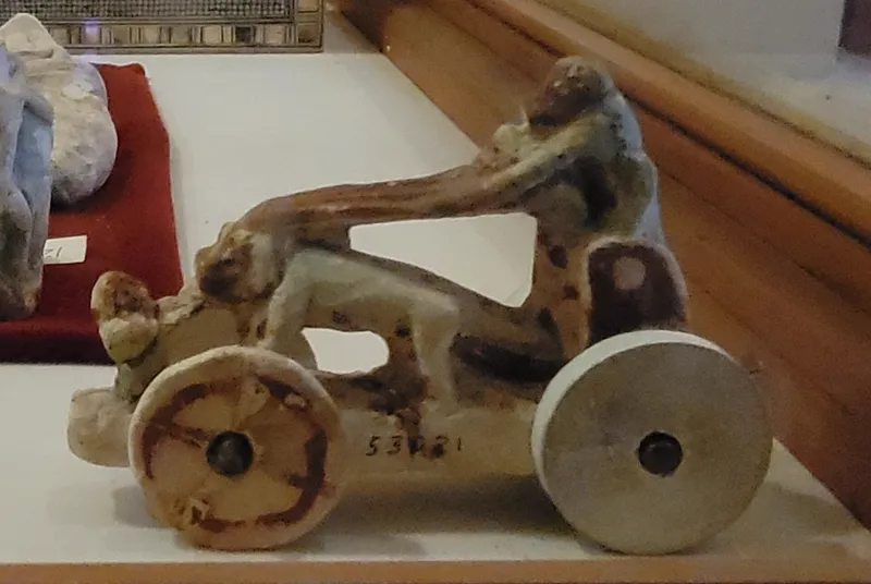A painted toy from Amarna: three monkeys riding in a chariot. Egyptian Museum, Cairo.