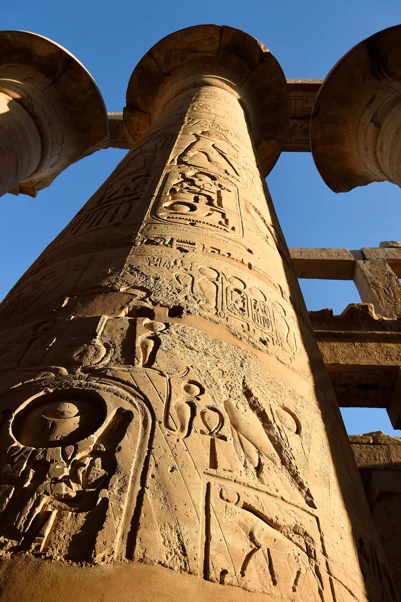Carvings cover the columns at Karnak, and some of the old paint survives.