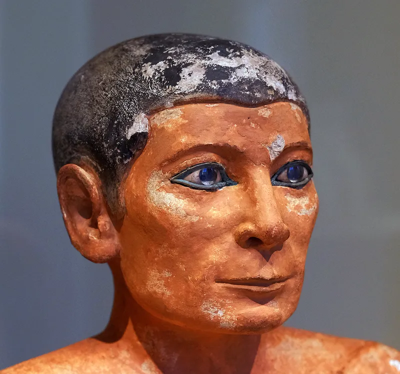 The Seated Scribe, a painted limestone statue about 4,500 years old. Louvre, Paris.