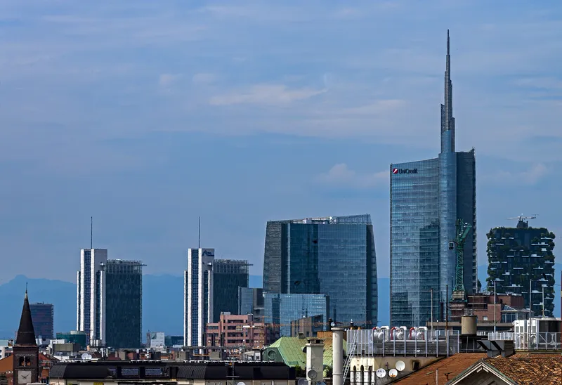 The two tree-covered towers of Bosco Verticale (right) on the Milan skyline.