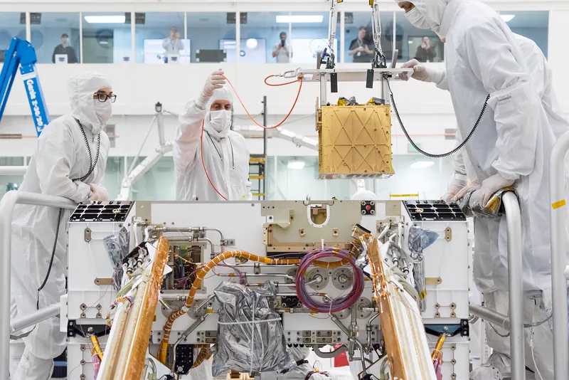 Engineers installing MOXIE, the oxygen-making experiment, into the Perseverance rover.