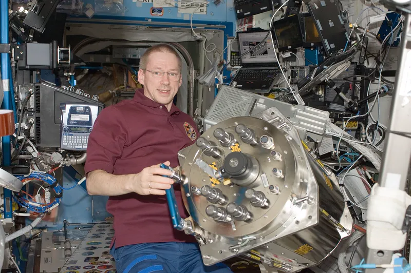 An astronaut working on part of the space station's urine processor, which turns urine back into drinking water.