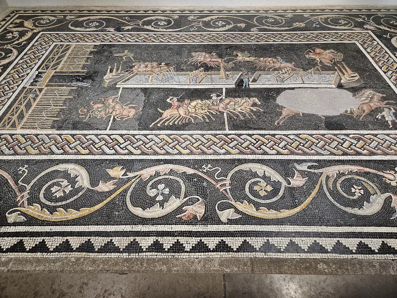 A Roman mosaic from Lyon, France, showing a chariot race in a circus, with the central barrier.