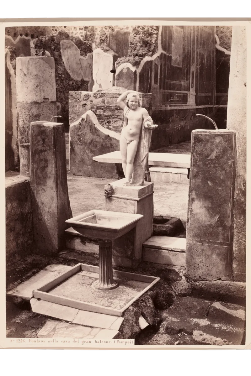 A small fountain inside a Pompeii house, photographed in the early 1900s.